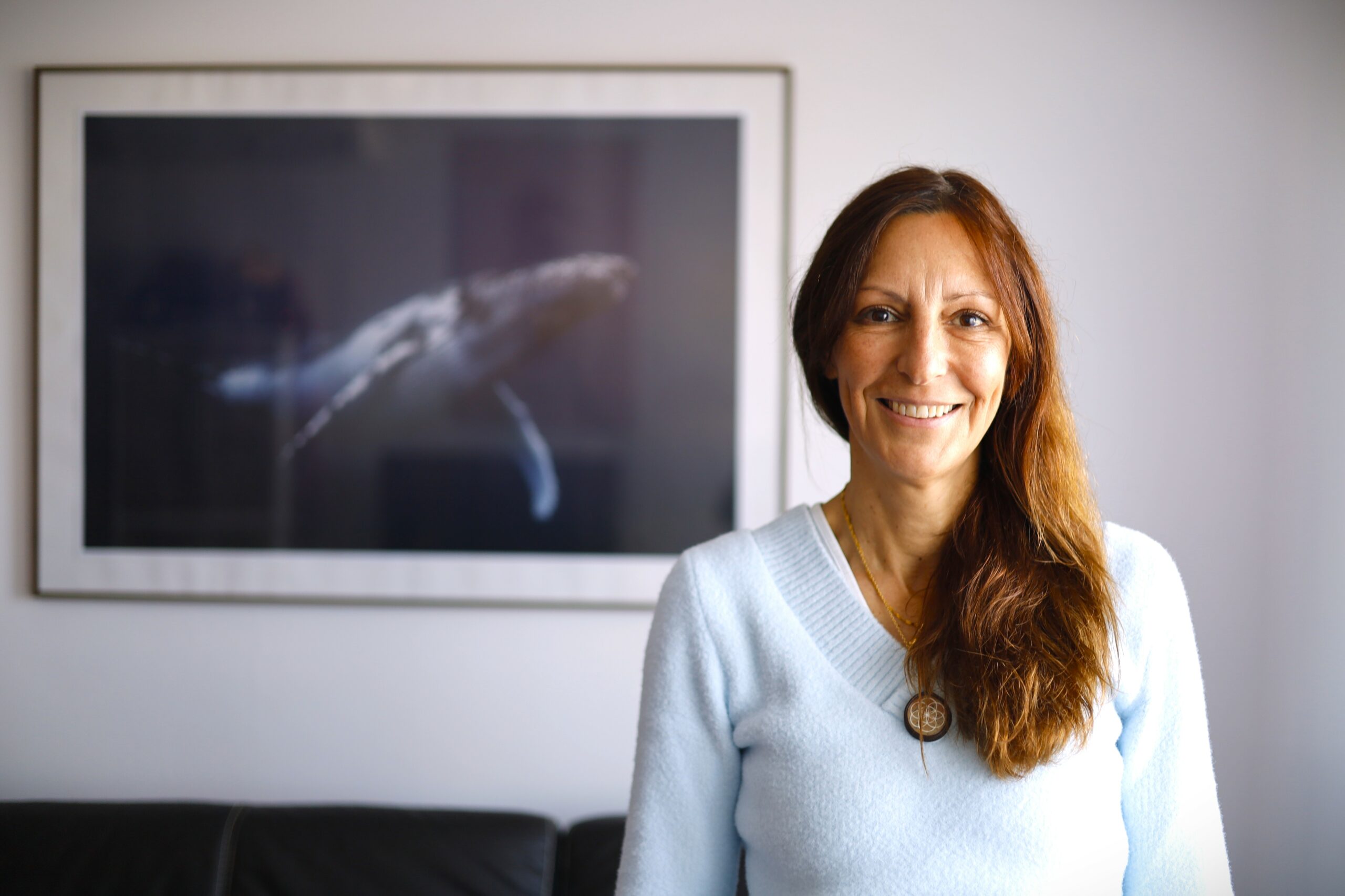 Agnès Ferrand souriante en séance de sophrologie aquatique à Bastia, devant une fresque marine